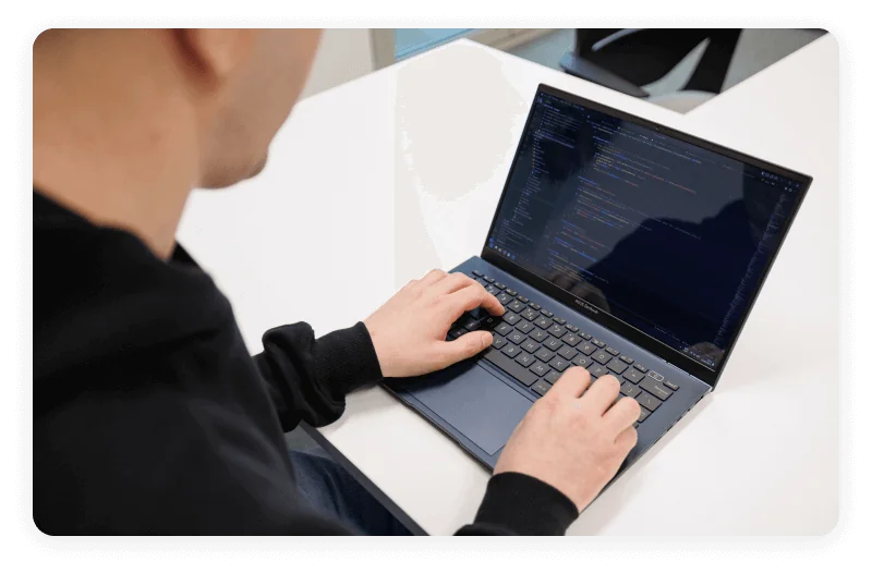 A photo showing somene working on a laptop